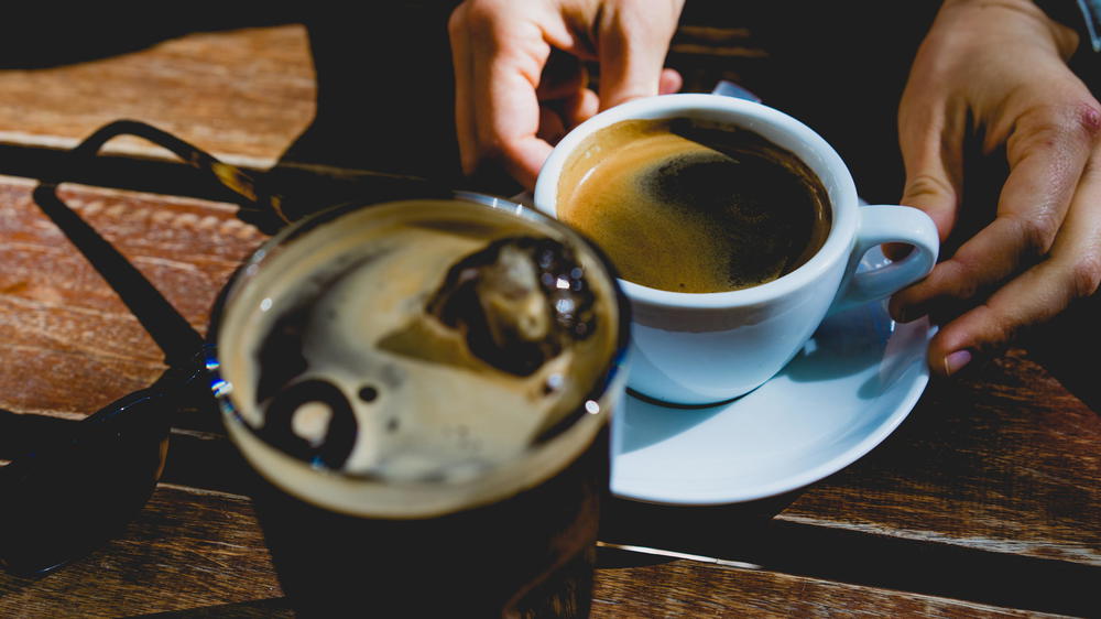 A person is holding a cup of coffee.