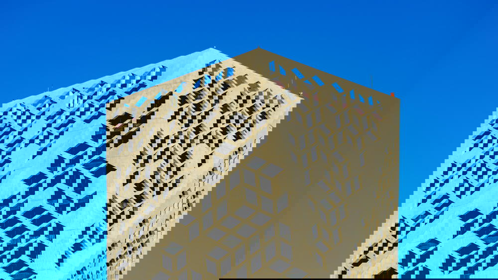 A tall building with a blue sky behind it.