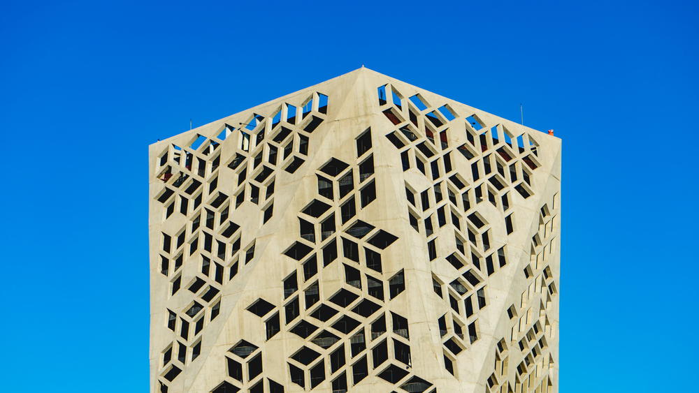 A tall building with a blue sky behind it.