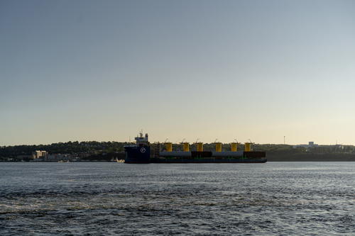 A large cargo ship in the middle of a body of water