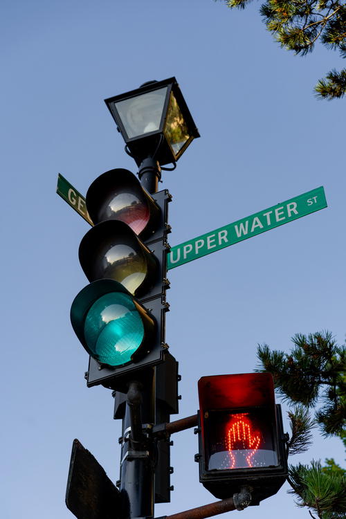 A traffic light with a street sign on it