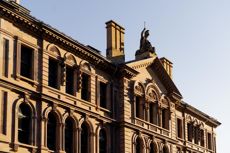 A large building with a statue on the top of it