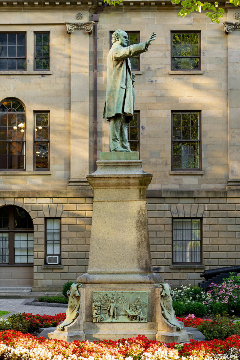 A statue of a man in front of a building