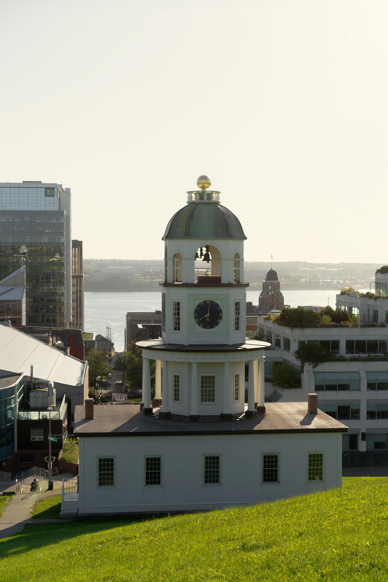 A large white building with a clock on the top of it