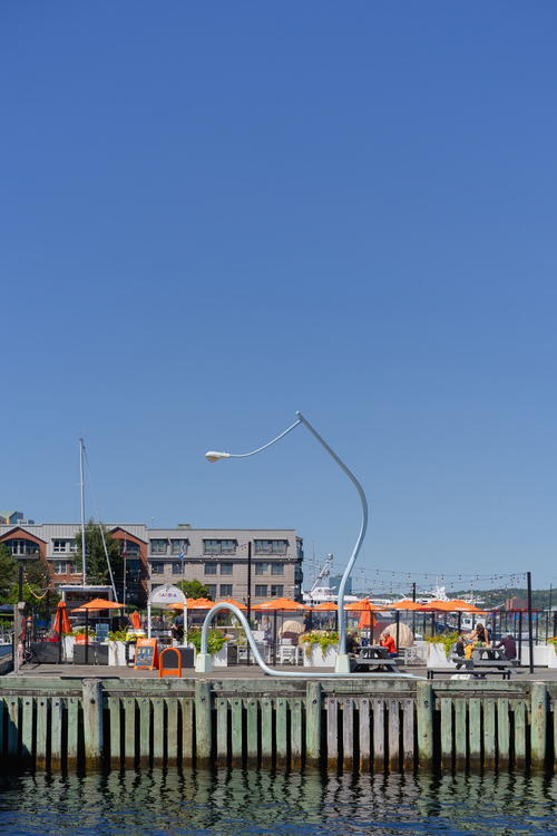 A boat dock with a bunch of orange umbrellas