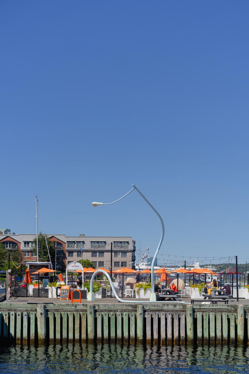 A boat dock with a bunch of orange umbrellas