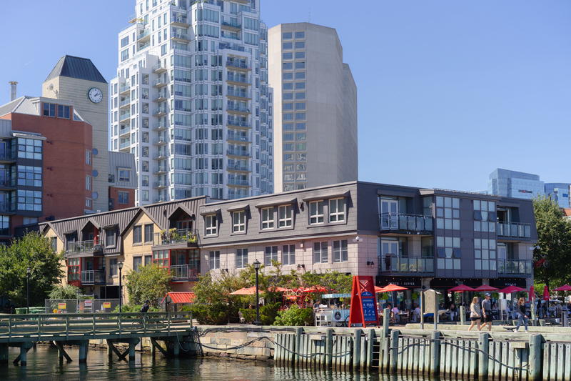 A group of buildings next to a body of water