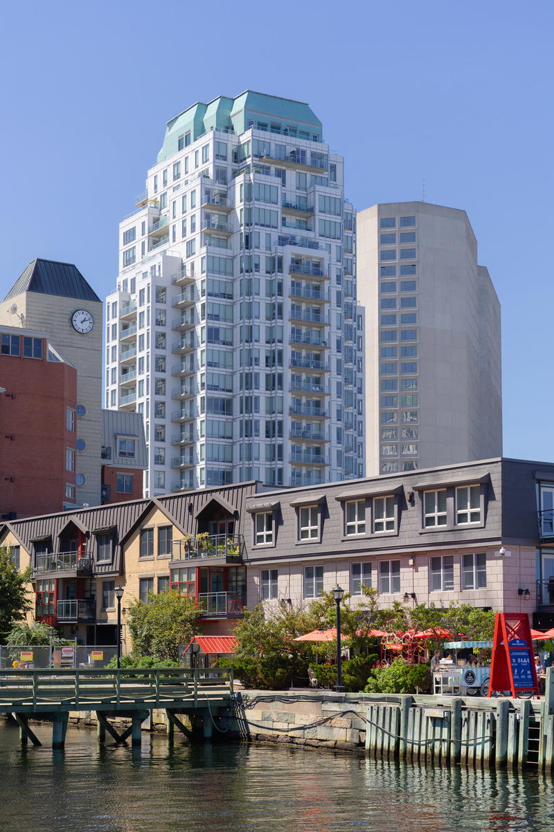 A body of water with buildings in the background