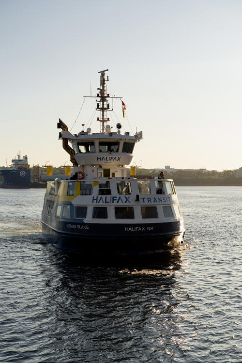 A boat is traveling down a body of water in Halifax, Canada.