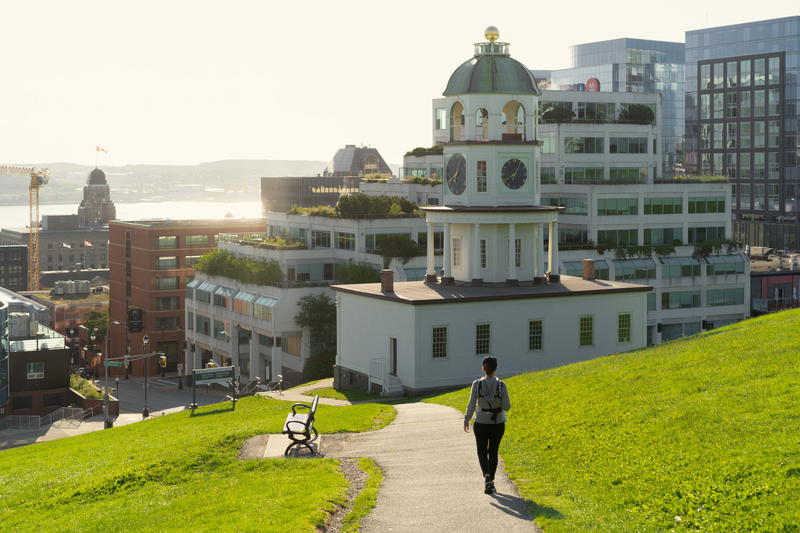 A person walking down a grassy path in Halifax, Canada.