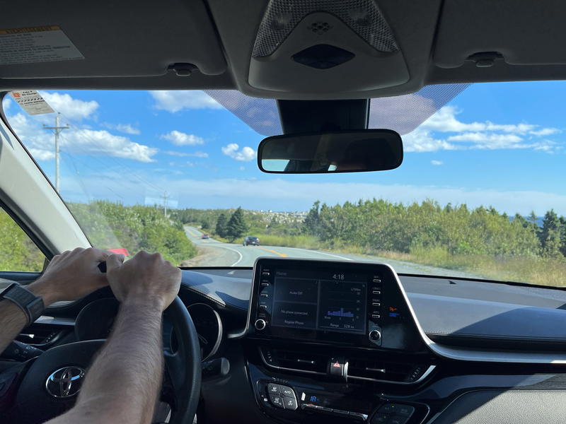 A man driving a Toyota Prius on a road in Halifax, Canada.