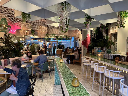 The interior of a restaurant in Halifax, Canada with people sitting at tables.