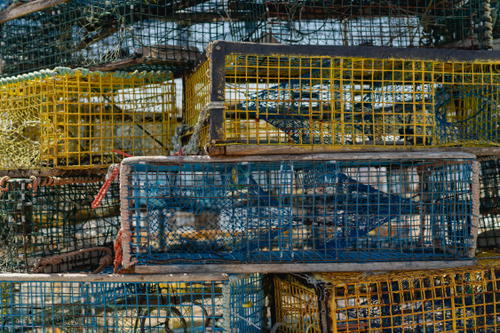 A bunch of cages that are stacked on top of each other