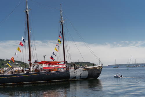A boat with flags on it floating in the water