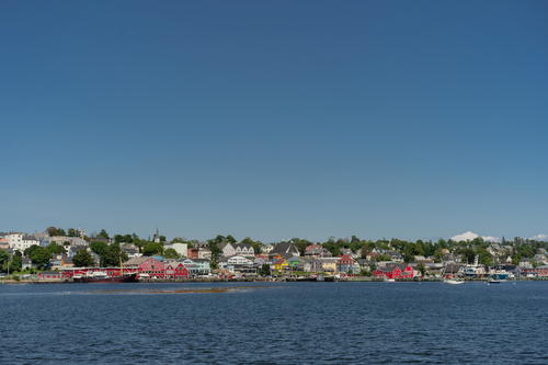 A body of water with houses in the background