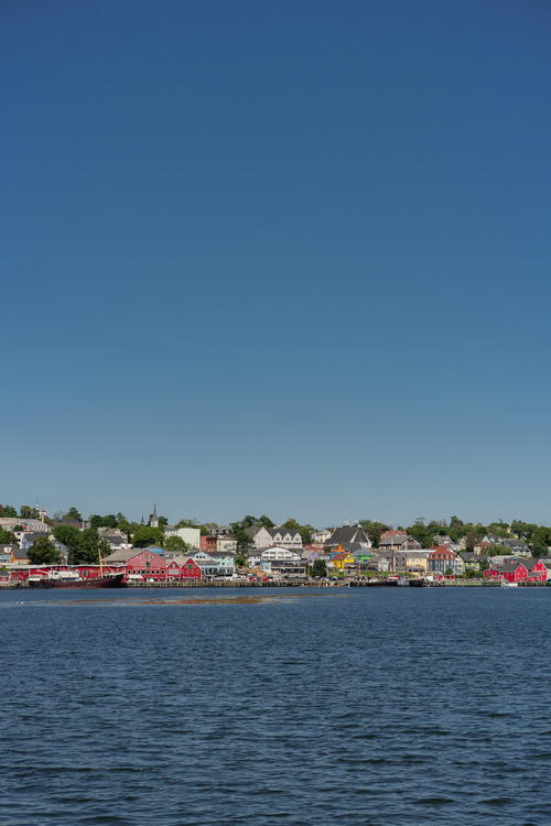 A large body of water with houses in the background