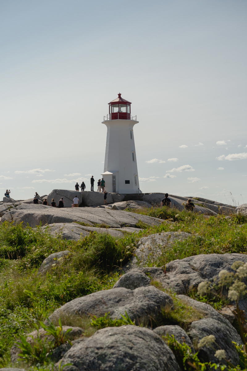 A light house on top of a rocky hill