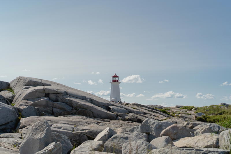 A lighthouse on top of a rocky outcropping