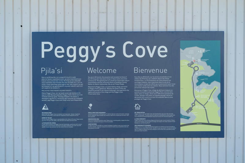 A sign on the side of a building that says peggy's cove