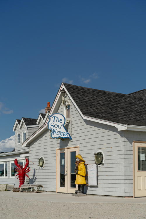 A person in a yellow jacket standing outside of a building