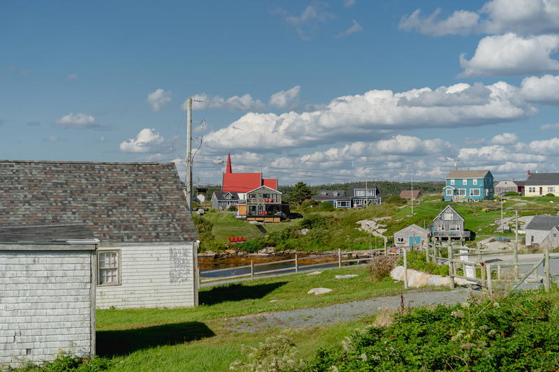 A small village with a few houses on the other side of the road