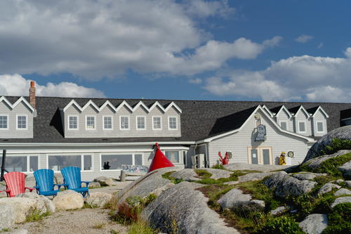 A large house with lawn chairs in front of it