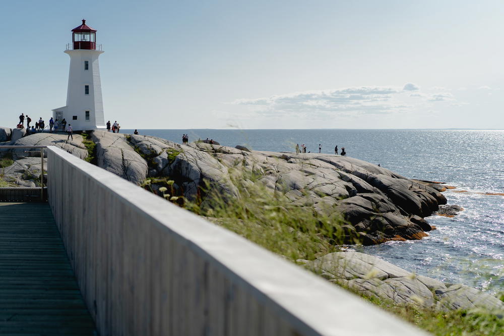 A light house sitting on top of a cliff next to the ocean