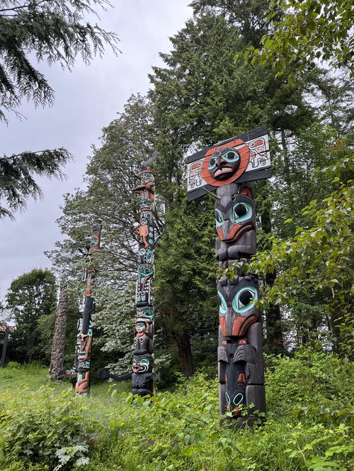 A totema statue in a forest with trees in the background