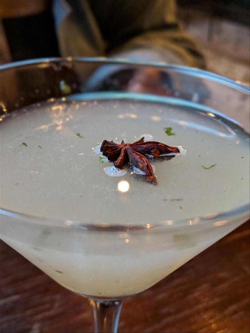 Close up of a cocktail with a dried star anise