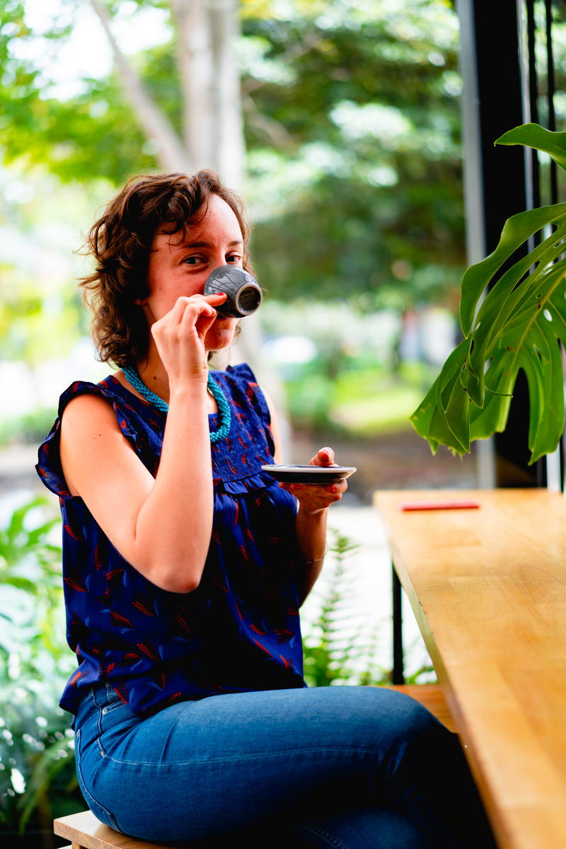 A woman sitting on a wooden bench.