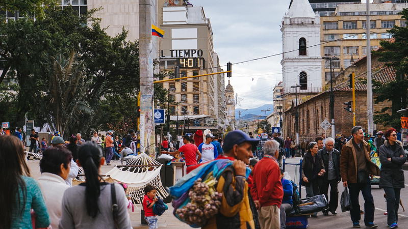 A group of people walking down a street.