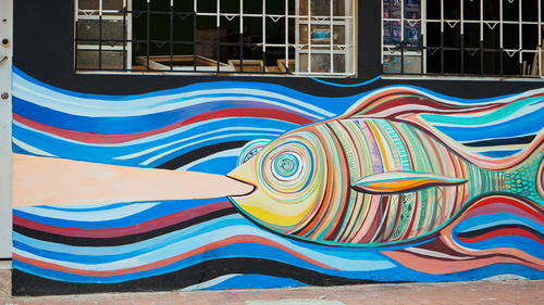 A mural of a fish on the side of a building.