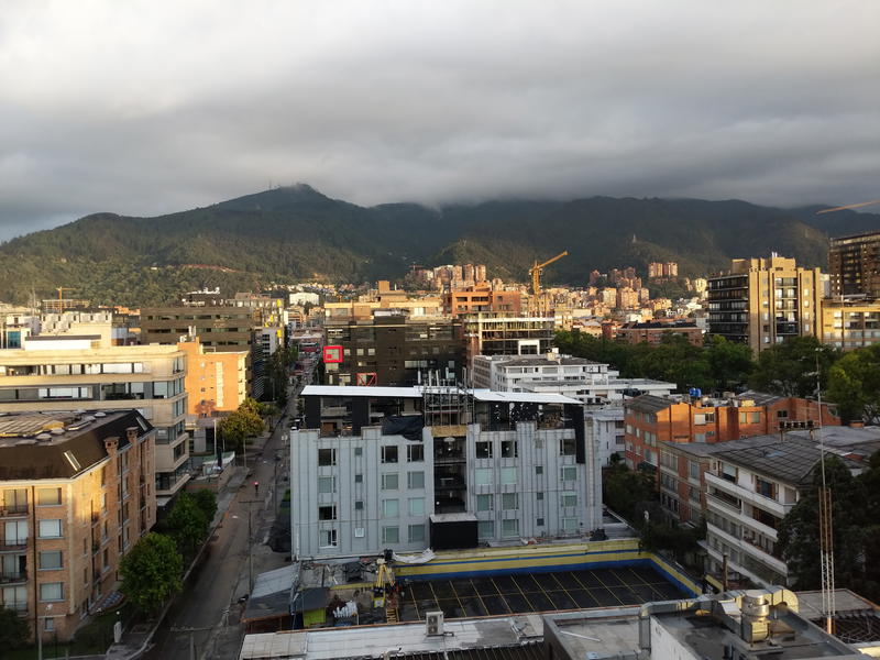 A view of a city with mountains in the background.