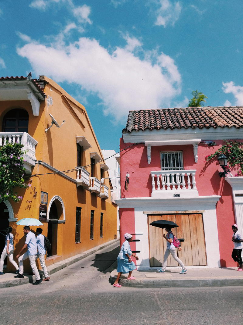 A group of people walking down a street.