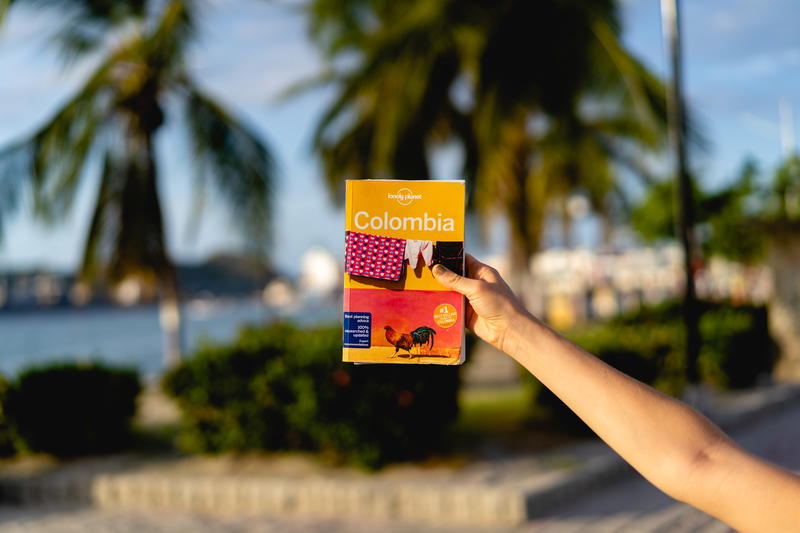 A woman holding up a map of colombia.