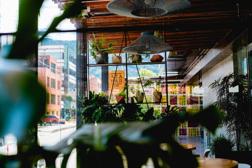 A table and chairs in a restaurant with a view of the street.