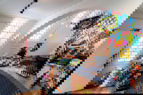 A man is standing behind a counter in a coffee shop.