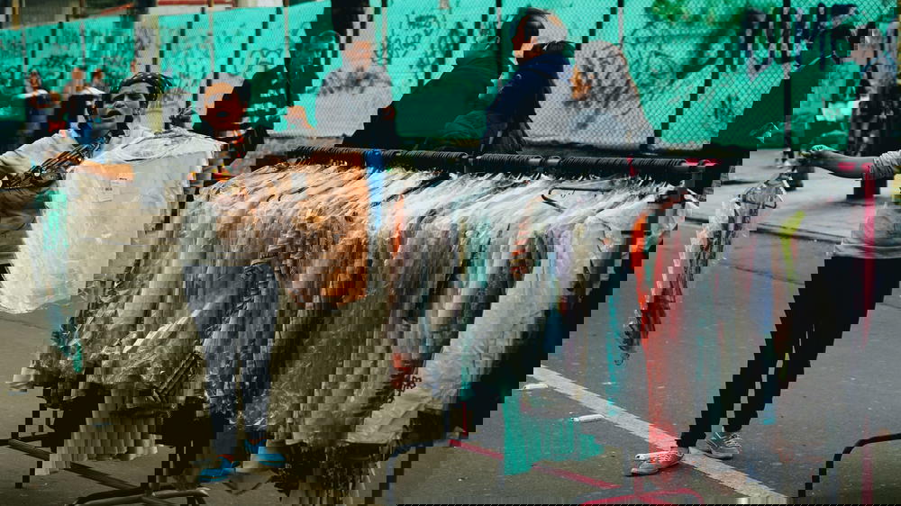 A woman selling clothes on a street in colombia.