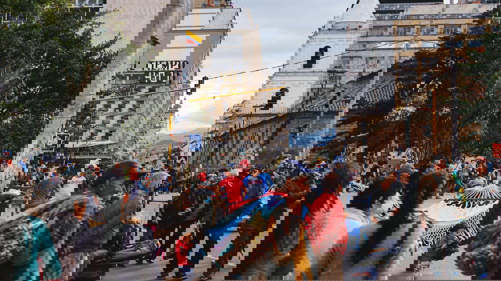 A group of people walking down a street.