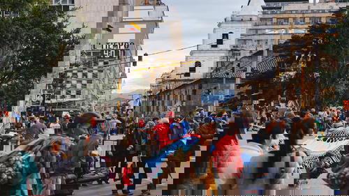 A group of people walking down a street.
