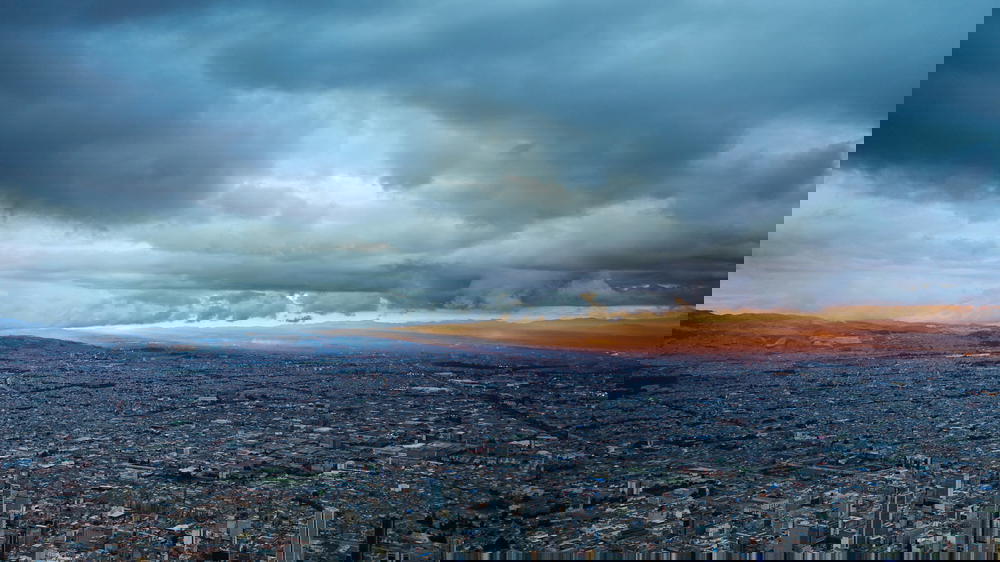 A cloudy sky over a city.