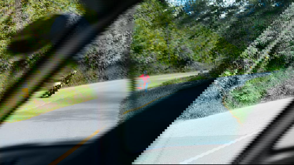 A man riding a motorcycle down a winding road.