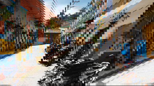 A row of motorcycles parked on a street.