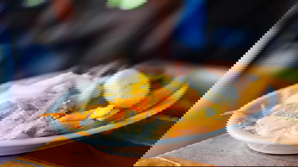 A plate of food on a wooden table.