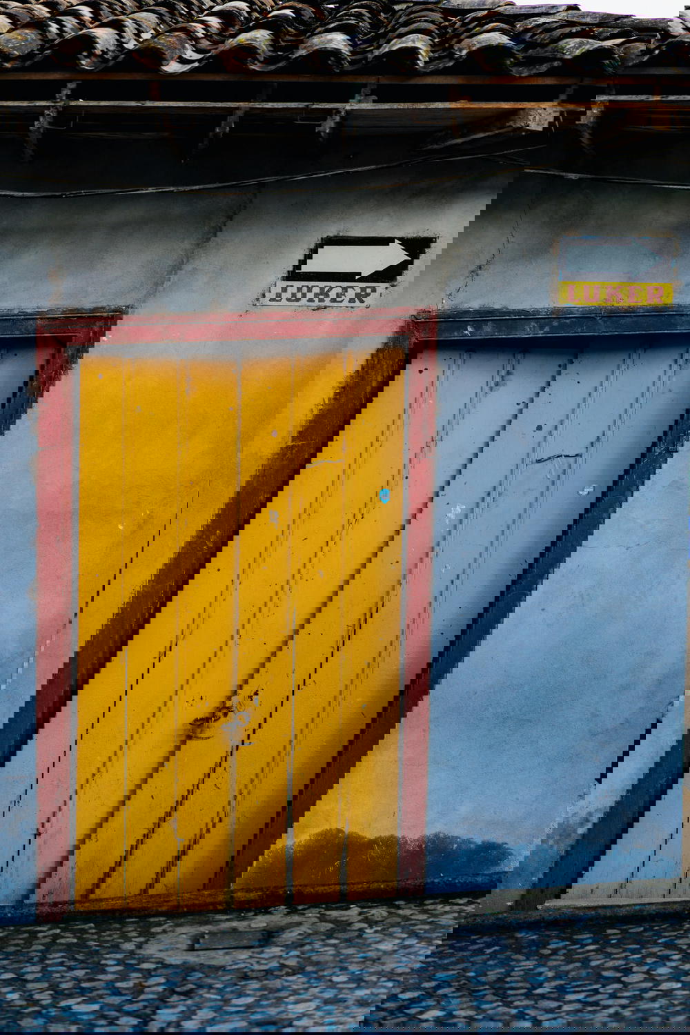 Yellow wooden door in Guatape Colombia