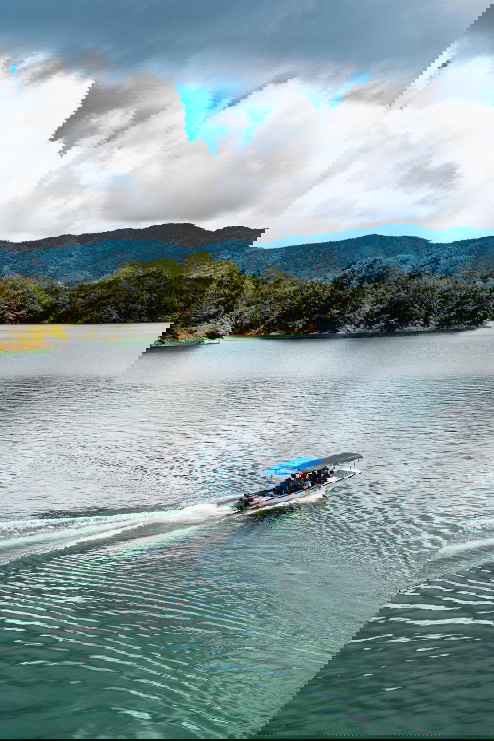 Boat in the water of the lake near the big rock in Guatape Colombia