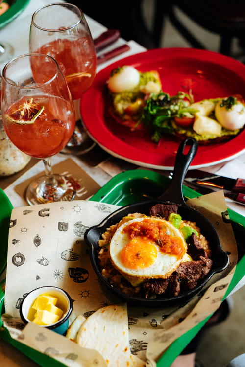 A table topped with plates of food and drinks