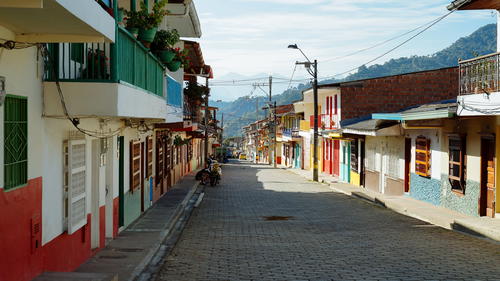 A cobblestone street lined with colorful buildings