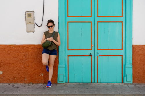 A woman standing in front of a blue door