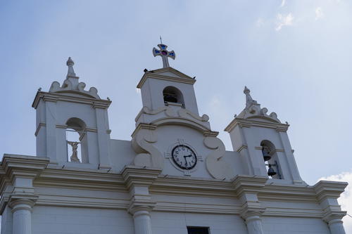 A large white building with a clock on it's side